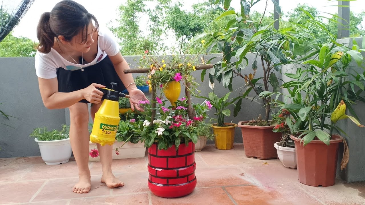 beautiful single mom recycling plastic bottles into beautiful flower pots | gardening ideas for home